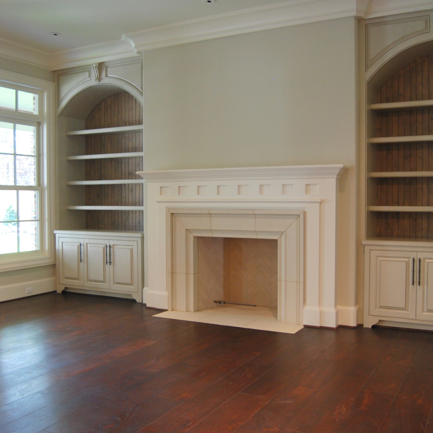 Newly remodeled living room with fireplace and built-in bookshelves