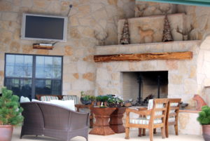 Patio design with a TV and fireplace