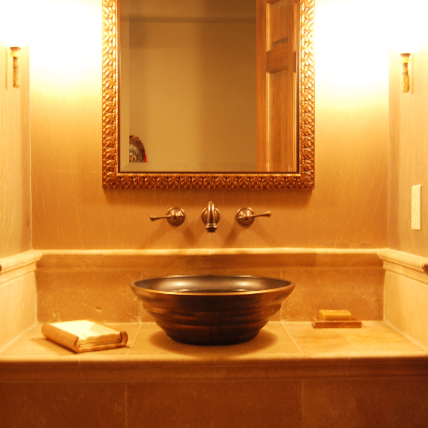 New bathroom sink with ornate gold mirror