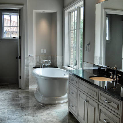 Newly remodeled master bathroom with black marble countertops