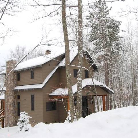 Exterior of a lake house in the snow