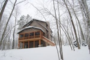 Exterior view of a lake house in the snow