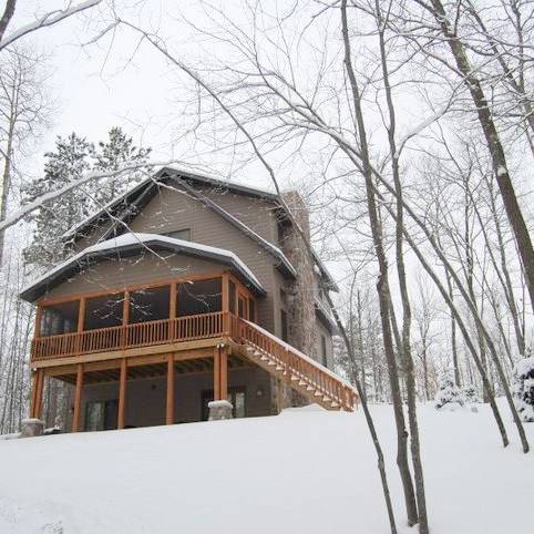 Exterior view of a lake house in the snow