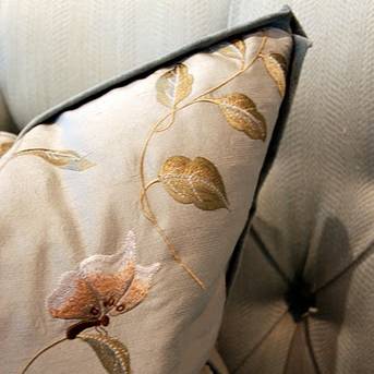 Embroidered floral details on a throw pillow