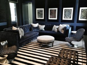 Dark living room interior design with blu velvet sofa