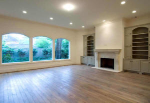 Newly renovated empty living room with fireplace