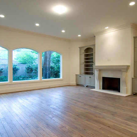 Newly renovated empty living room with fireplace