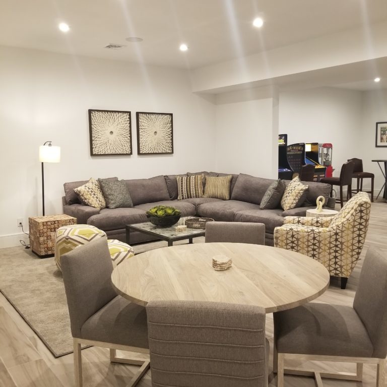 Basement living area interior design with sofas and dining table