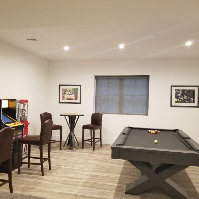 Game room interior design with pool table and arcade machines
