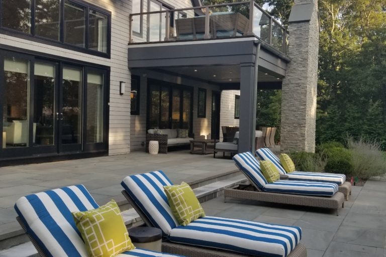 Outdoor patio design with blue and white striped lounge chairs