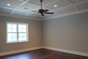Empty room with natural lighting and ceiling fan