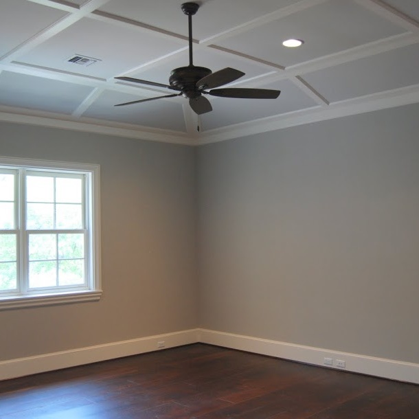 Empty room with natural lighting and ceiling fan