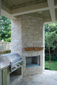 Outdoor patio design with grill and wood stove